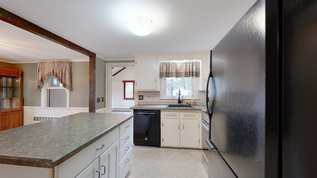 10 Wayland Road Wakefield, MA 01880 - Photo 12 of 28 a kitchen with a sink stove and refrigerator