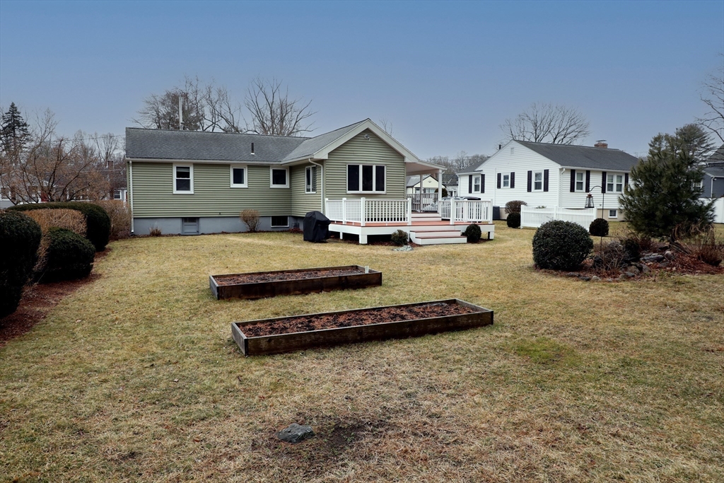 10 Wayland Road Wakefield, MA 01880 - Photo 5 of 28 a front view of a house with a yard outdoor seating and garage