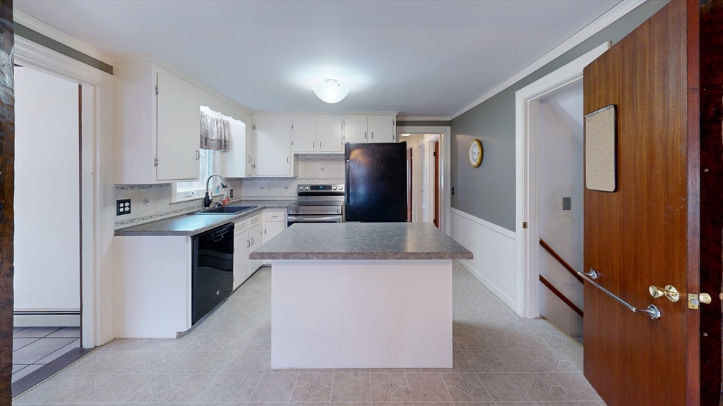 10 Wayland Road Wakefield, MA 01880 - Photo 9 of 28 a kitchen with stainless steel appliances granite countertop a refrigerator a stove and a sink