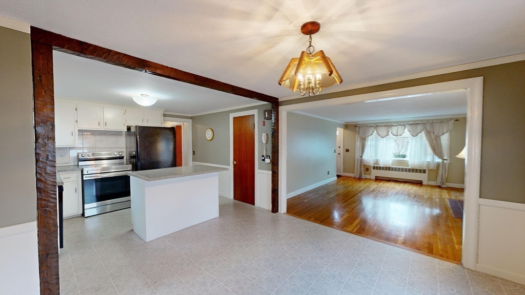 10 Wayland Road Wakefield, MA 01880 - Photo 10 of 28 a view of a kitchen with a sink and dishwasher a refrigerator with wooden floor