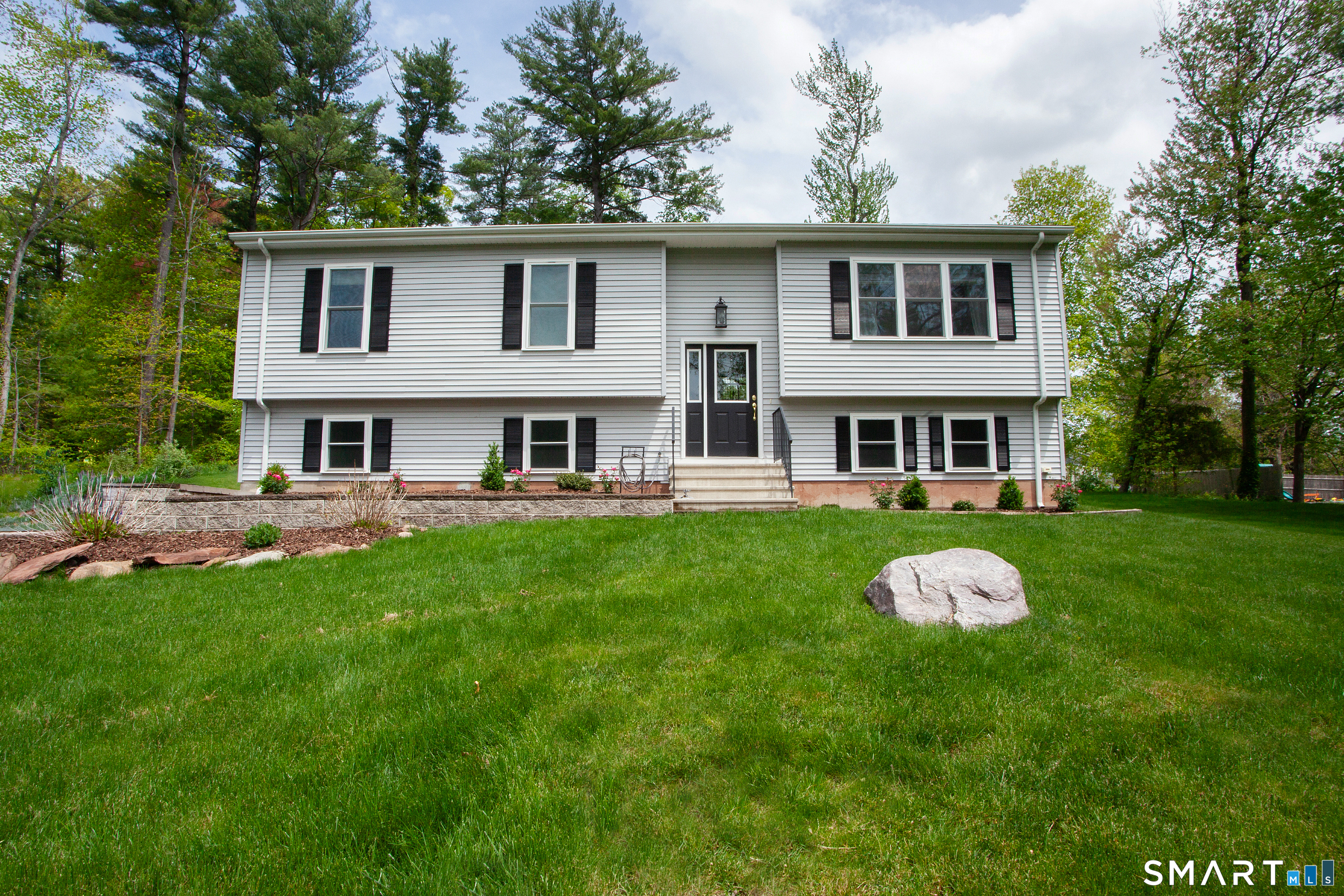 93 Rye Hill Circle Somers, CT 06071 - Photo 1 of 33 a front view of a house with a garden