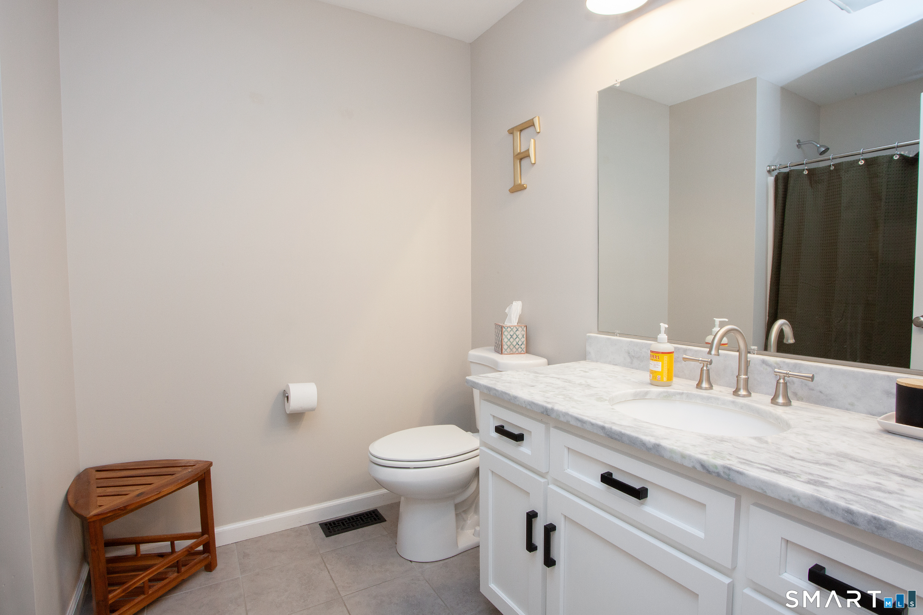 93 Rye Hill Circle Somers, CT 06071 - Photo 18 of 33 a bathroom with a granite countertop toilet and sink