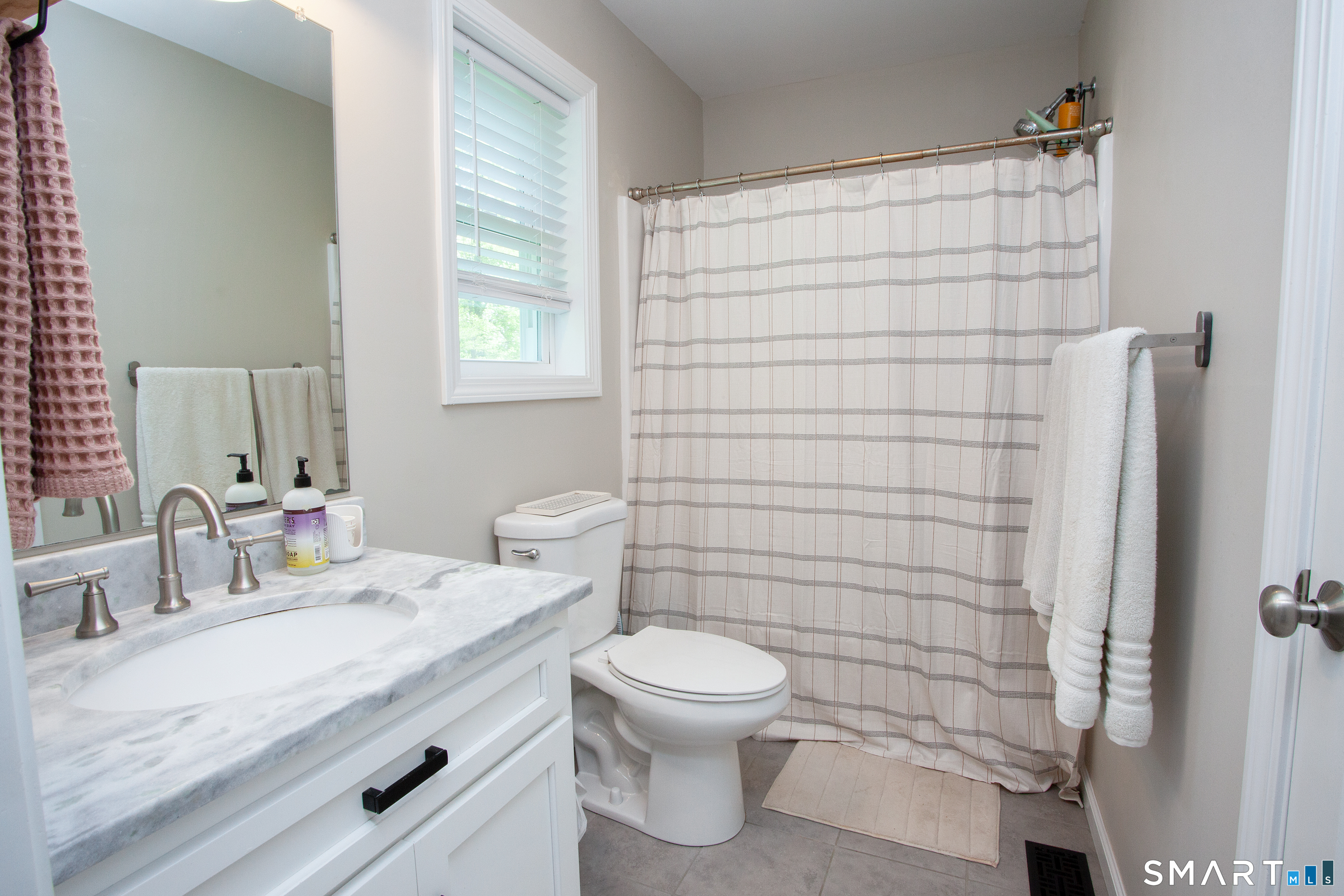93 Rye Hill Circle Somers, CT 06071 - Photo 28 of 33 a bathroom with a granite countertop toilet a sink a shower and a mirror