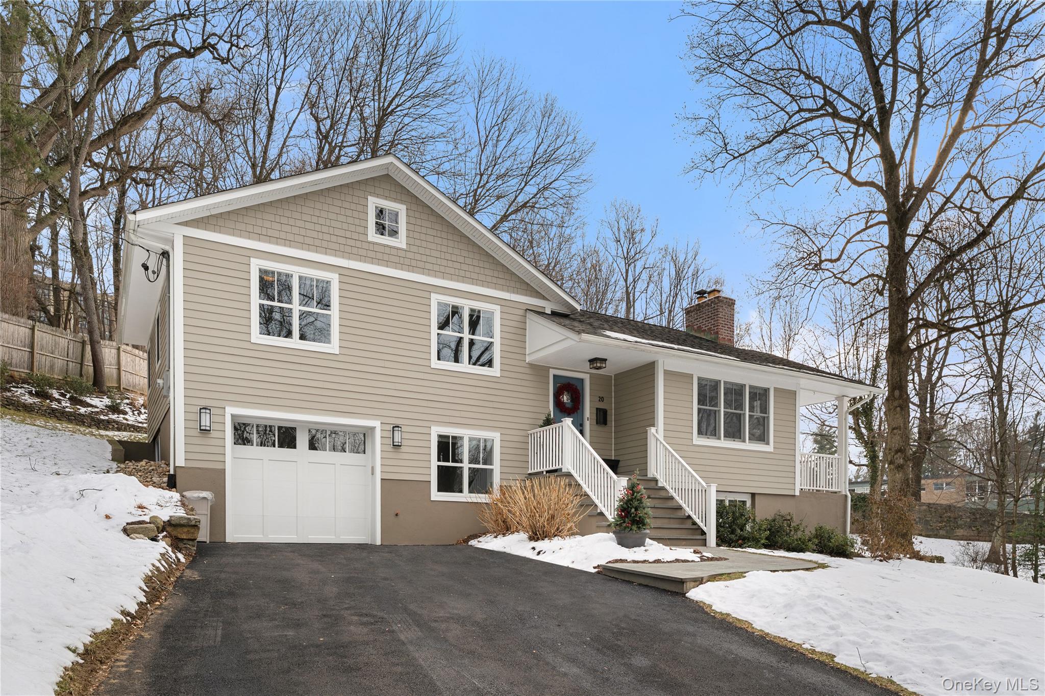 a view of a house with a yard covered in snow