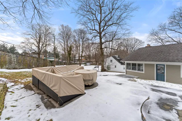 a view of a house with a yard covered in snow