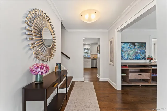 a view of entryway with furniture and wooden floor