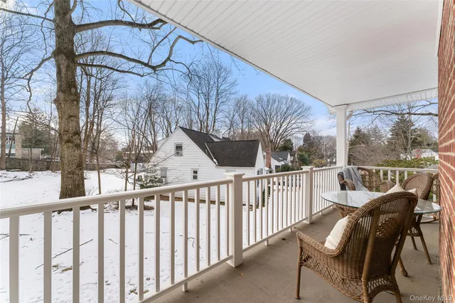 a view of a chair and table in the balcony