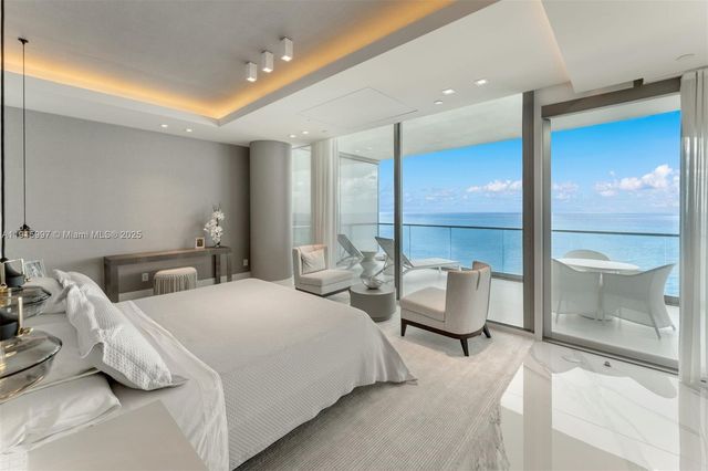 a bedroom with furniture and a large window