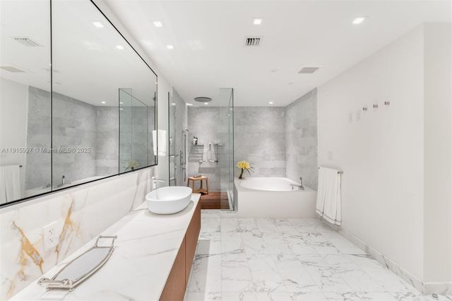 a bathroom with a double vanity sink mirror and