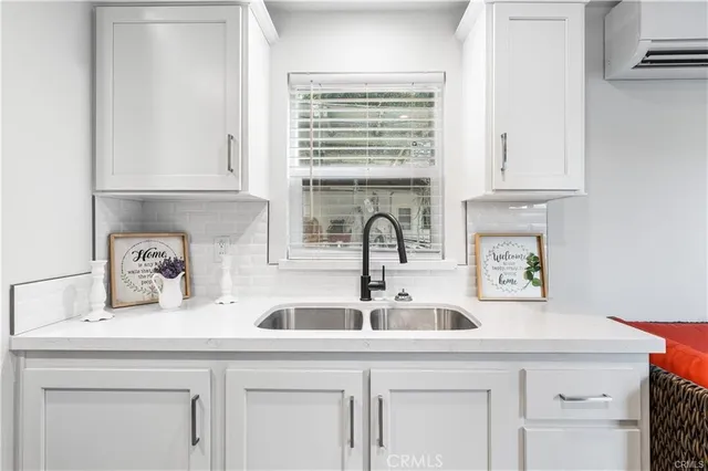 a kitchen with cabinets and window