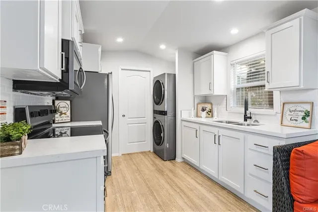 a kitchen with stainless steel appliances a refrigerator sink and cabinets