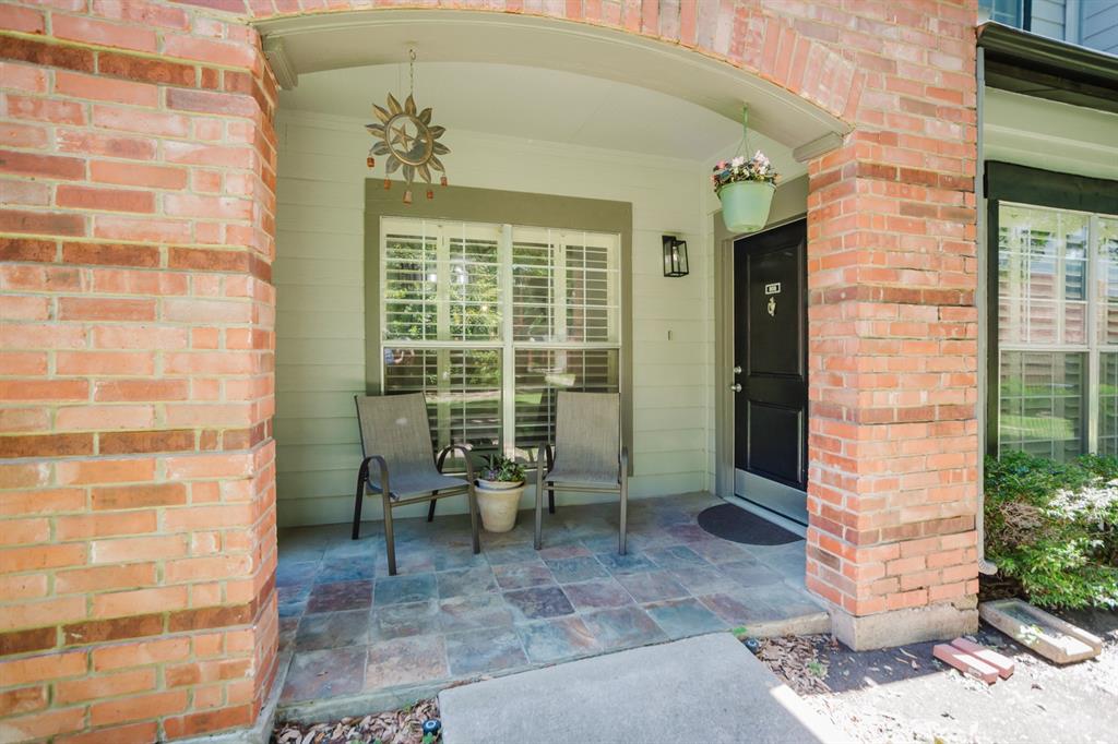2524 Preston Road, Unit 808 Plano, TX 75093 - Photo 8 of 31 Covered front porch featuring brick columns and a multi-toned tile floor
