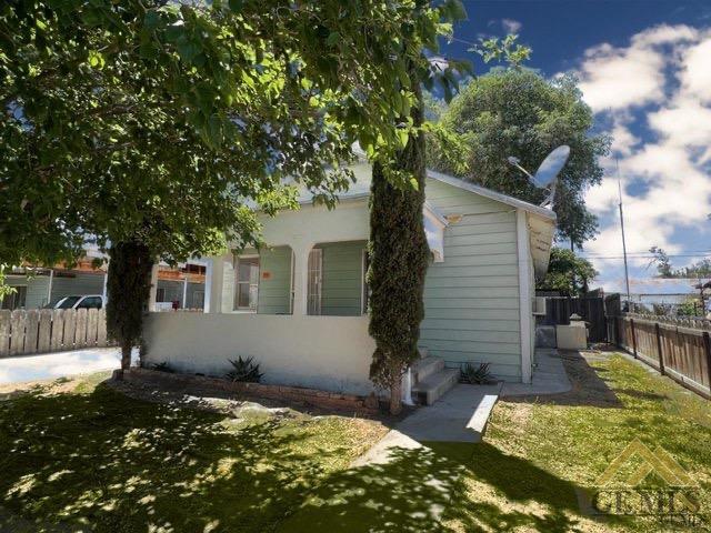 a backyard of a house with yard and outdoor seating