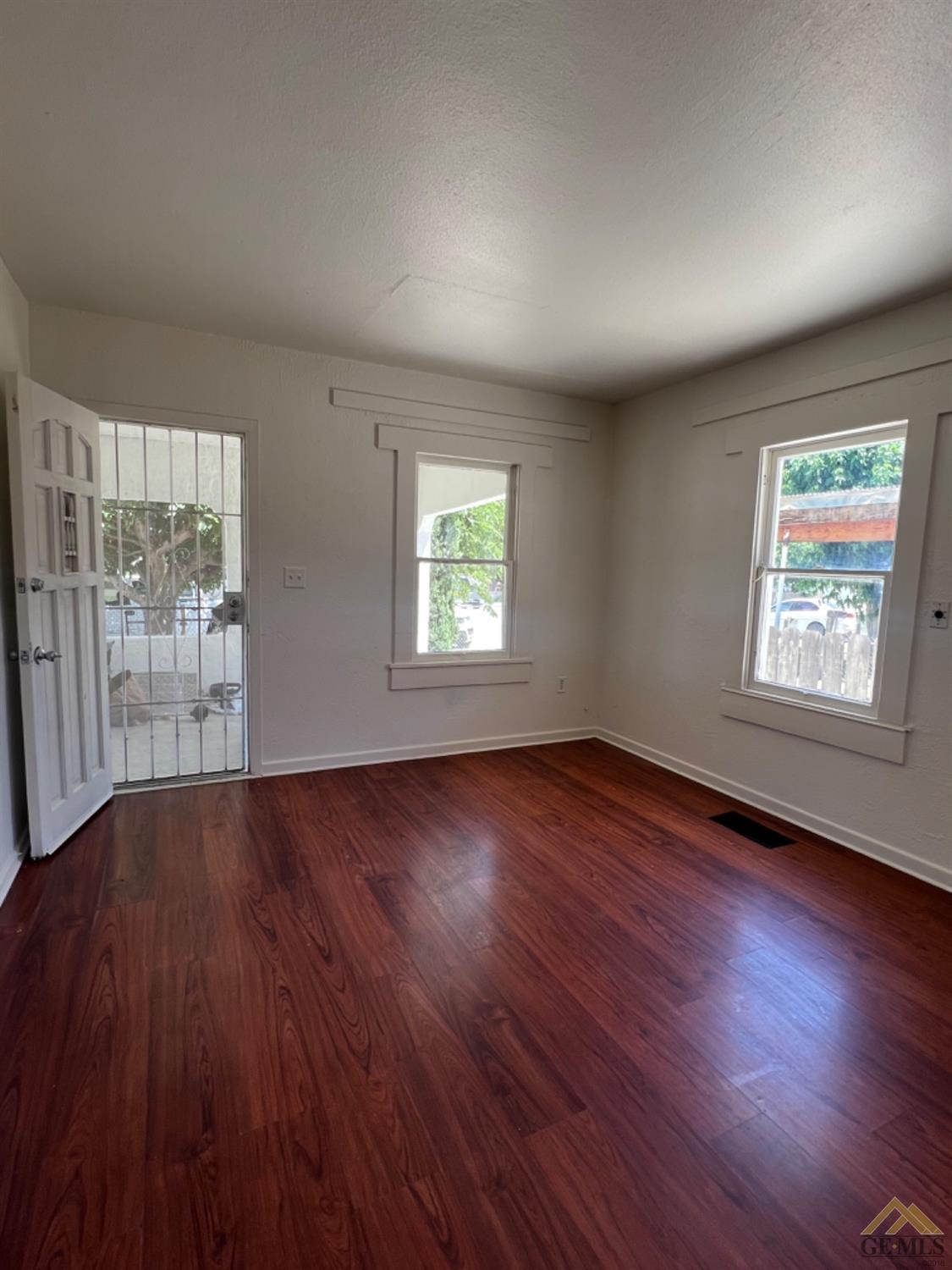 Undisclosed Address Taft, CA 93268 - Photo 4 of 18 an empty room with wooden floor and windows
