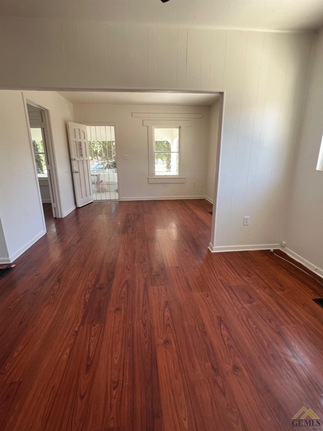 Undisclosed Address Taft, CA 93268 - Photo 5 of 18 an empty room with wooden floor and windows