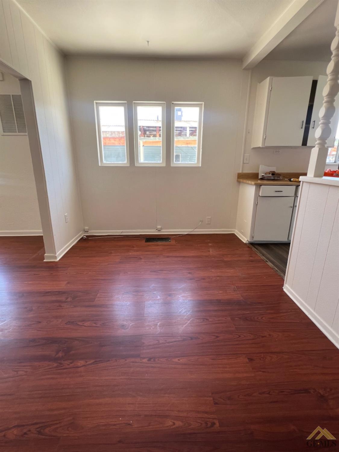 Undisclosed Address Taft, CA 93268 - Photo 6 of 18 an empty room with wooden floor and windows