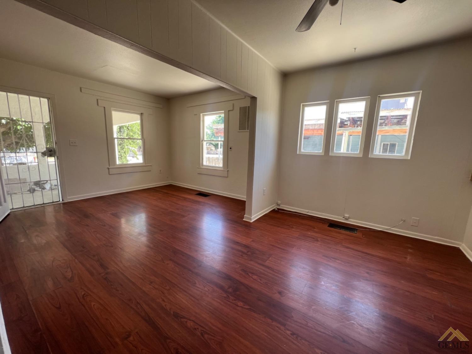 Undisclosed Address Taft, CA 93268 - Photo 7 of 18 a view of an empty room with wooden floor and a window