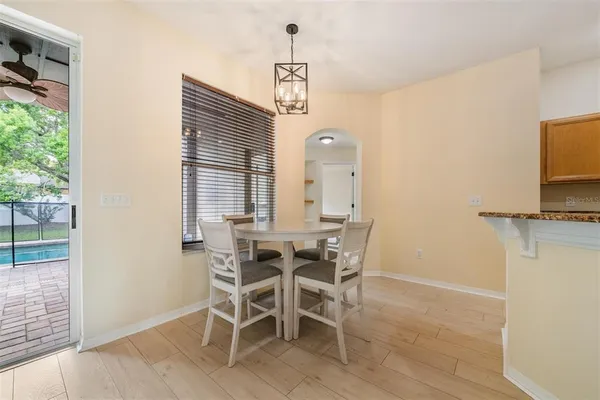 a view of a dining room with furniture and a chandelier