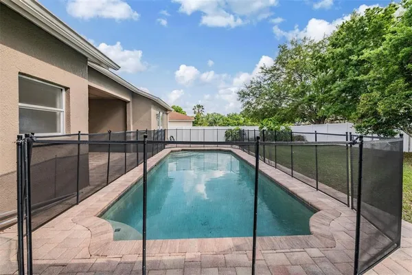 an outdoor view of house with backyard and swimming pool