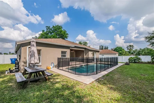 a view of a house with a yard and sitting area