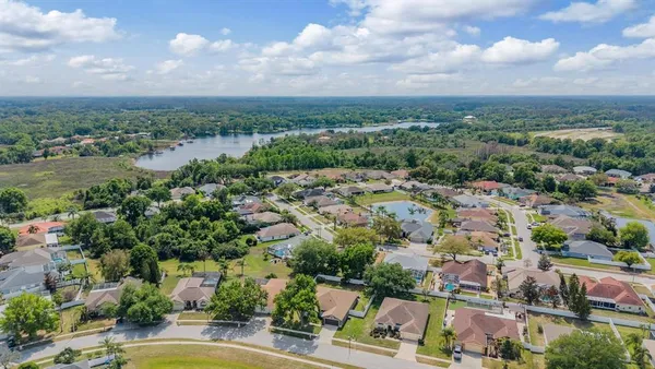 a aerial view of a house with swimming pool next to a yard