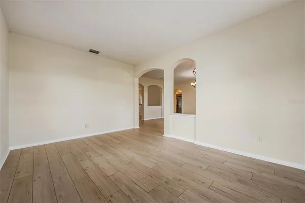 a view of a room with wooden floor and window