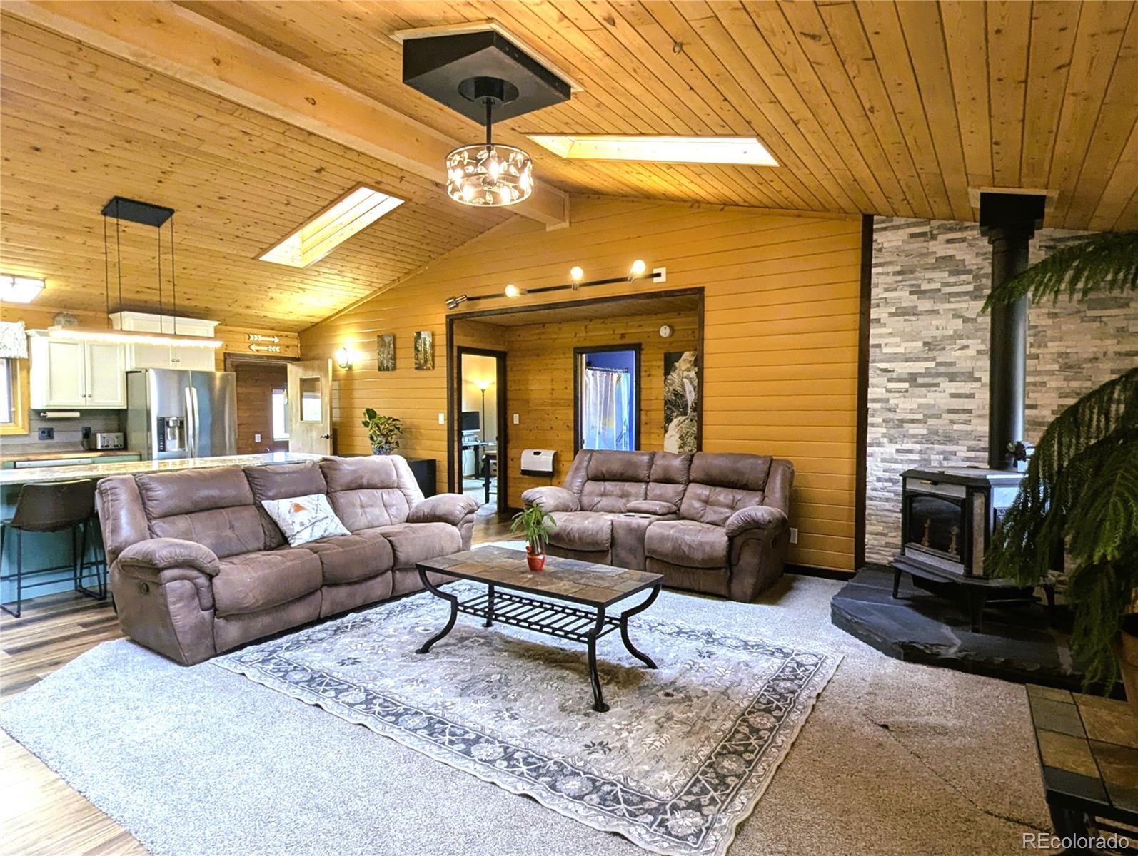 2084 Forbes Park Road Fort Garland, CO 81133 - Photo 16 of 39 a living room with furniture and a fireplace