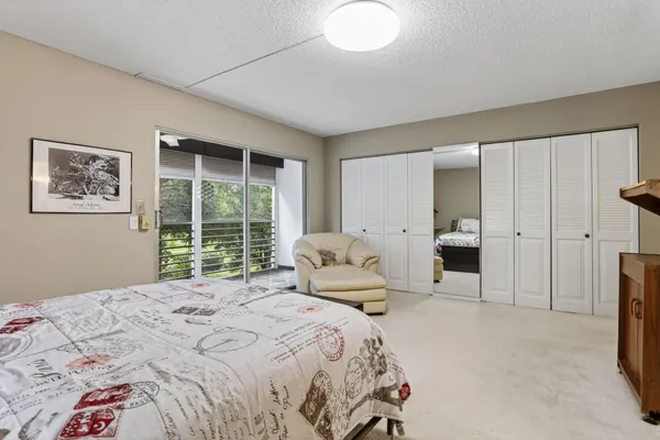 a bedroom with a large bed and a large window