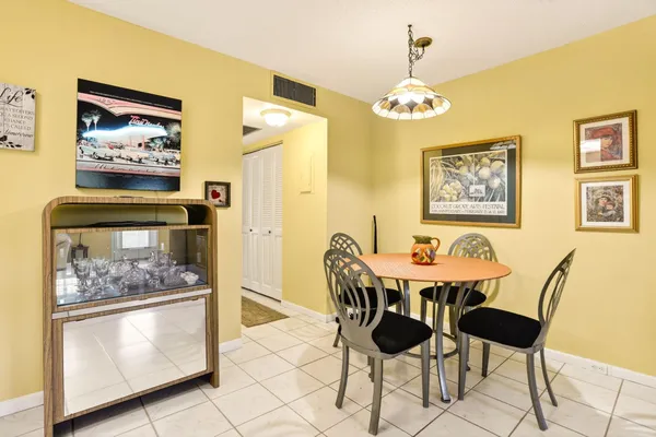 a dining room with furniture and chandelier