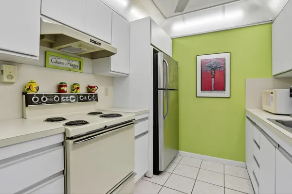 a kitchen with stainless steel appliances granite countertop a refrigerator and a stove