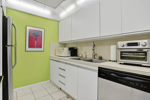 a kitchen with sink and cabinets