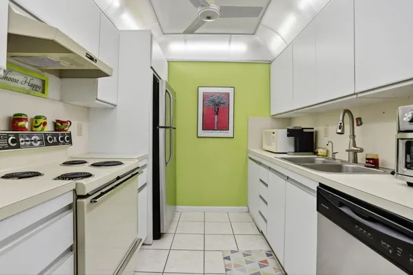 a kitchen with stainless steel appliances a stove a sink and a refrigerator