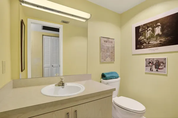 a bathroom with a toilet a sink and mirror