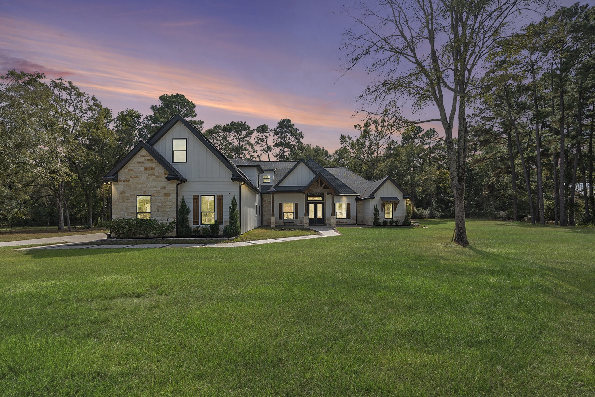 11211 Leonidas Horton Road Conroe, TX 77304 - Photo 3 of 47 Twilight view of this exquisite home on a serene 1.42-acre lot!