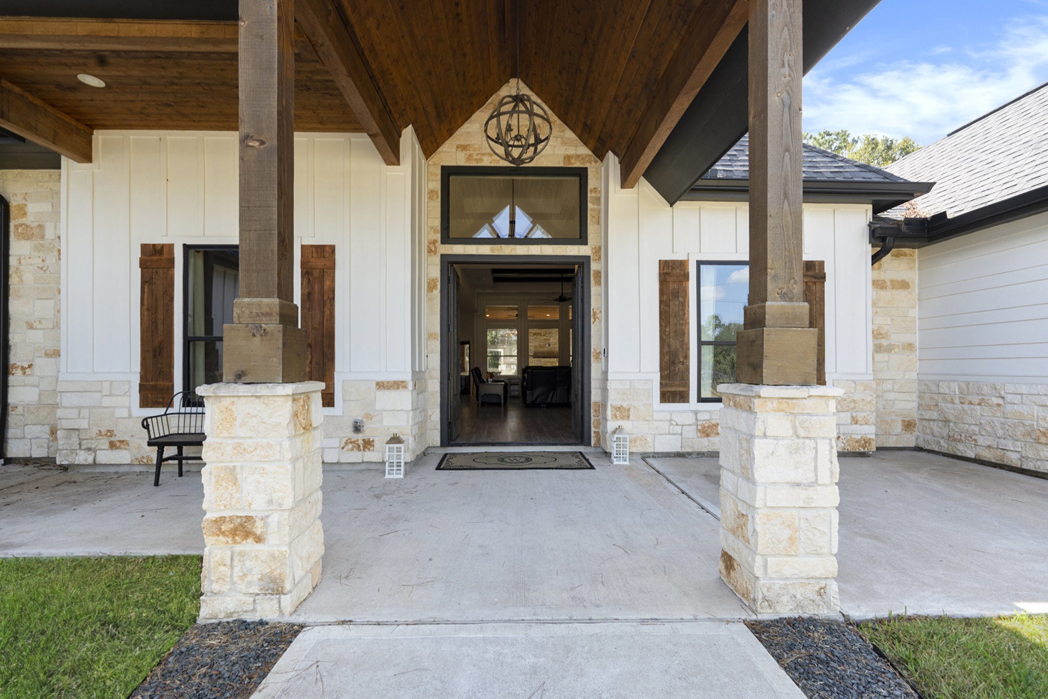 11211 Leonidas Horton Road Conroe, TX 77304 - Photo 4 of 47 A striking entryway with a soaring wood-beam ceiling and stone accents creates an unforgettable first impression.