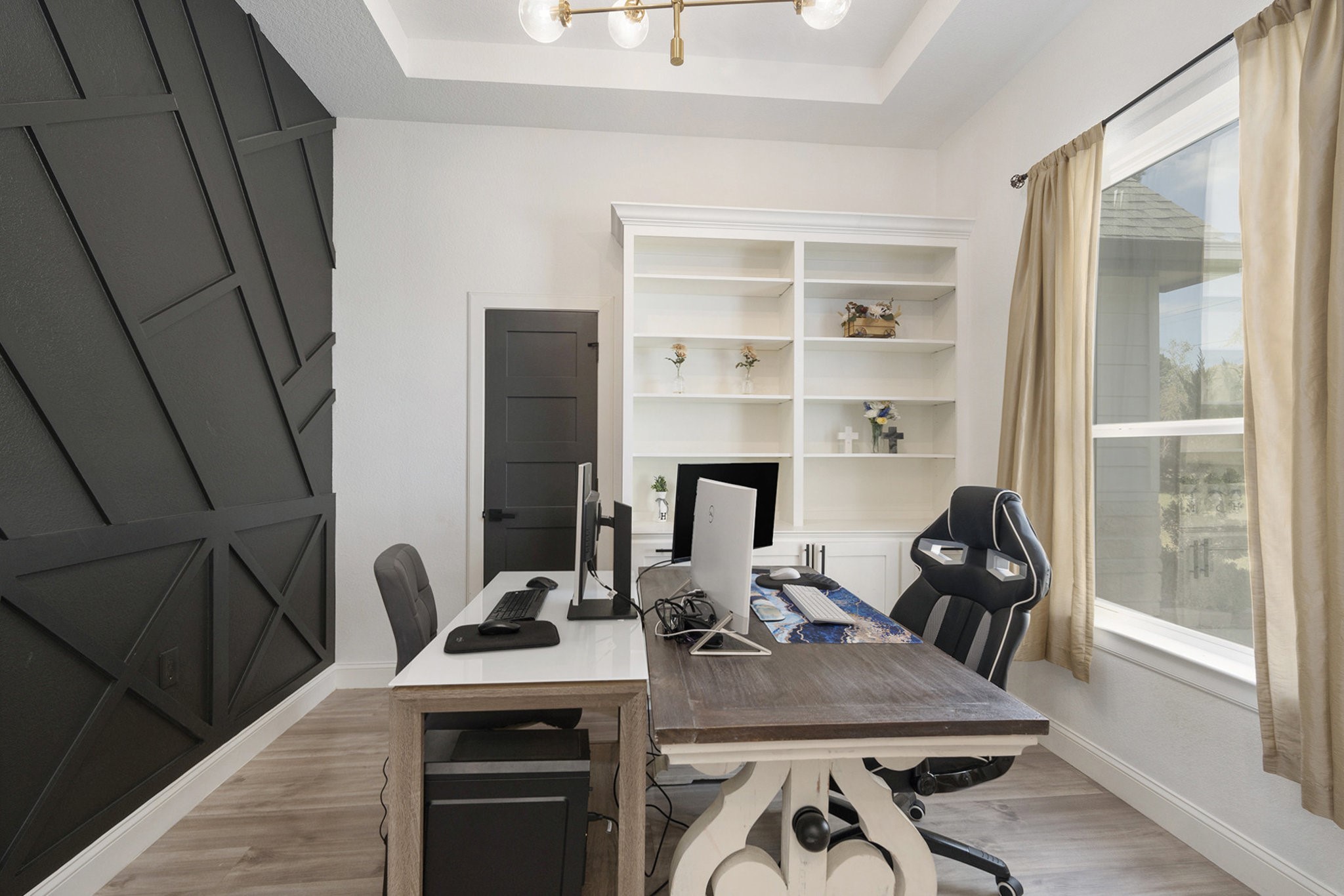 11211 Leonidas Horton Road Conroe, TX 77304 - Photo 6 of 47 Stylish home office with a bold accent wall, custom built-in shelving, and a large window that fills the space with natural light.
