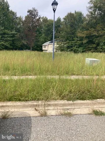 a backyard of a house with a yard and outdoor seating