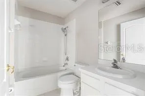 a bathroom with a sink a toilet a mirror and bathtub
