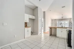 a kitchen with white cabinets and a sink