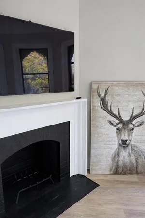 a view of a livingroom with a fireplace and wooden floor