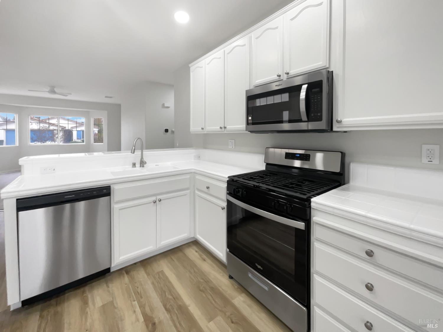 971 Bridgeport Way Rio Vista, CA 94571 - Photo 10 of 39 a kitchen with stainless steel appliances white cabinets and a stove top oven