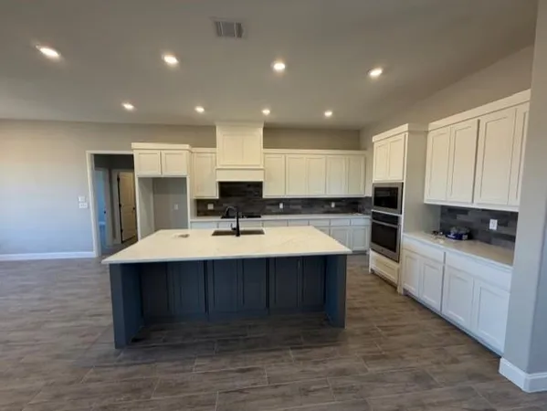 a kitchen with kitchen island sink stainless steel appliances and cabinets