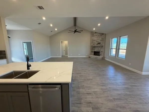 a kitchen with kitchen island a sink stainless steel appliances and window