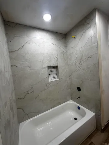 a bathroom with a tub and shower
