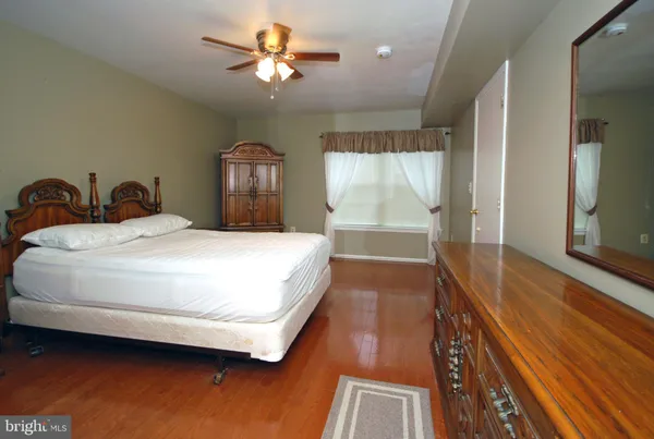 a bedroom with a bed and a view of balcony