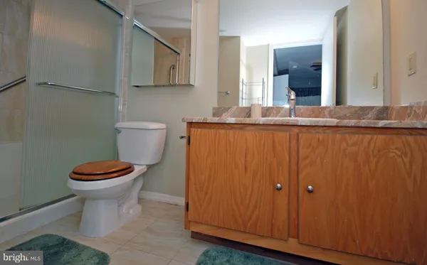 a bathroom with a toilet a sink and mirror