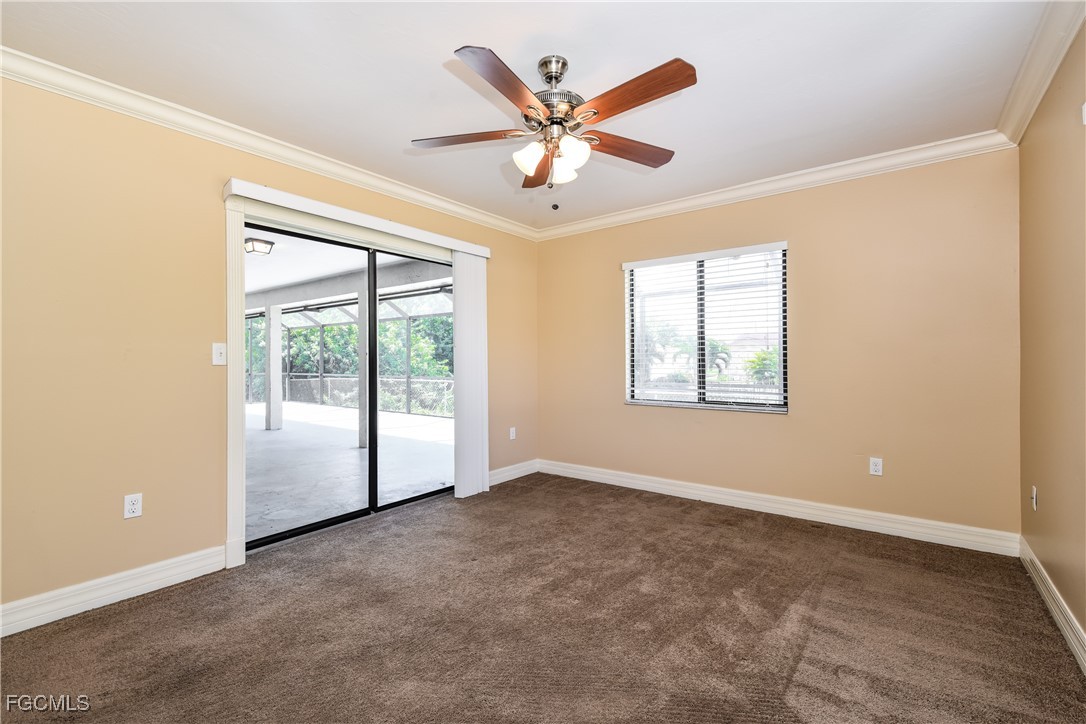 17365 Castile Road Fort Myers, FL 33967 - Photo 12 of 16 an empty room with ceiling fan and windows
