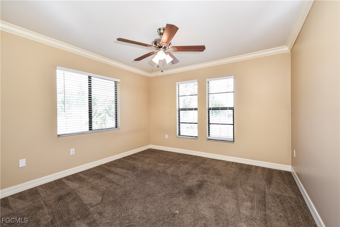 17365 Castile Road Fort Myers, FL 33967 - Photo 13 of 16 a view of an empty room with chandelier fan and fire place