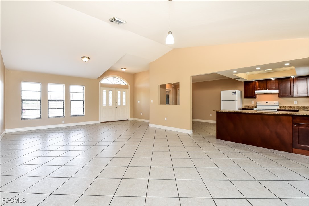 17365 Castile Road Fort Myers, FL 33967 - Photo 4 of 16 a view of an empty room with window and wooden floor