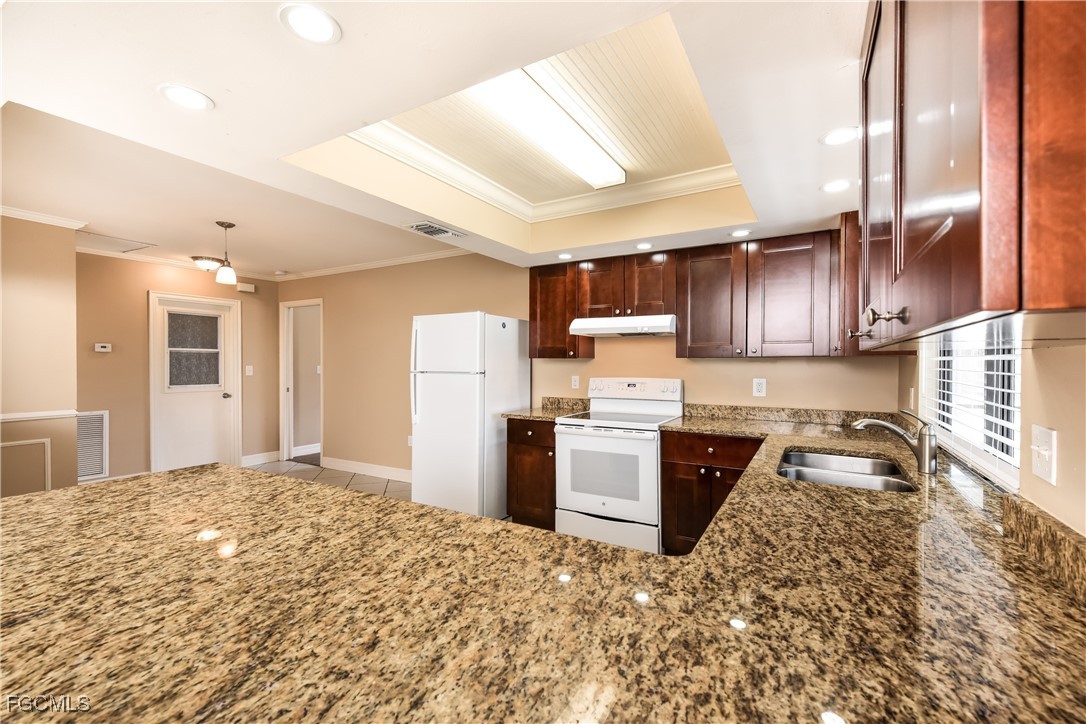 17365 Castile Road Fort Myers, FL 33967 - Photo 6 of 16 a kitchen with stainless steel appliances granite countertop a refrigerator sink and stove